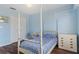Bedroom showcasing a four poster bed, closet and chest of drawers at 13140 Maycrest Ave, Weeki Wachee, FL 34614
