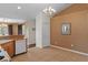 Cozy dining area featuring a chandelier, tan walls, and an adjacent kitchen bar for convenient serving at 13140 Maycrest Ave, Weeki Wachee, FL 34614