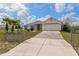 Charming single-story home with long driveway leading to attached two-car garage at 13140 Maycrest Ave, Weeki Wachee, FL 34614