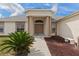 Inviting front entrance with elegant columns and manicured landscaping at 13140 Maycrest Ave, Weeki Wachee, FL 34614