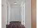 Hallway with multiple closets and wood floors at 13140 Maycrest Ave, Weeki Wachee, FL 34614