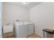 Laundry room with a utility sink, appliances, and tile flooring at 13140 Maycrest Ave, Weeki Wachee, FL 34614