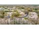 A distant aerial of the community showcasing tree lined streets and ponds at 13227 Molitor Ct, Hudson, FL 34669