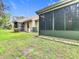 Exterior home view with enclosed patio, grassy yard, AC unit at 13227 Molitor Ct, Hudson, FL 34669