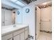 Bathroom showcasing a vanity with a mirror, tiled floors and decorative border, and access to other rooms at 13227 Molitor Ct, Hudson, FL 34669