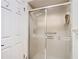 Bathroom featuring a glass shower door and a white door with coat hooks at 13227 Molitor Ct, Hudson, FL 34669