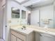 Bright bathroom features a vanity with decorative details and a mirror at 13227 Molitor Ct, Hudson, FL 34669