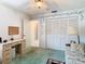 Well-lit bedroom with a spacious closet, adjacent to a desk and seating area at 13227 Molitor Ct, Hudson, FL 34669