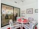 Enclosed patio with a dining table and chairs and slider looking into living room at 13227 Molitor Ct, Hudson, FL 34669
