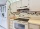 Well-lit kitchen featuring white cabinets, modern appliances, and tasteful decorative touches offering a warm, inviting space at 13227 Molitor Ct, Hudson, FL 34669