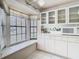 Modern kitchen features a bright window nook, sleek white cabinetry, and stainless steel microwave, enhancing the cooking space at 13227 Molitor Ct, Hudson, FL 34669