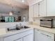 Bright kitchen features a stainless steel sink and dishwasher, with an open layout flowing into the adjacent living area at 13227 Molitor Ct, Hudson, FL 34669