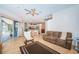 Open-concept living room with a view of the kitchen and screened in patio at 1528 Jutland Dr, Trinity, FL 34655
