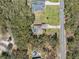 Aerial view of two homes with private pools and large yards surrounded by trees, and a long driveway at 18251 East Rd, Hudson, FL 34667