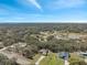 A panoramic aerial view of the neighborhood and surrounding lush greenery at 18251 East Rd, Hudson, FL 34667