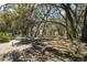 A treed backyard offers a serene and private outdoor space at 18251 East Rd, Hudson, FL 34667