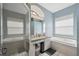 Bathroom featuring dual sinks, walk-in shower, jetted tub and neutral paint at 18251 East Rd, Hudson, FL 34667