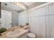 Well-lit bathroom with a large mirror, decorative shower curtain and vanity with sink at 18251 East Rd, Hudson, FL 34667