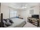 Comfortable bedroom with ceiling fan, dresser and tv at 18251 East Rd, Hudson, FL 34667