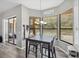 Dining area with view of the pool and patio, wood-look floors, and a modern chandelier at 18251 East Rd, Hudson, FL 34667