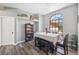 Cozy dining area with a display cabinet, gray flooring, and natural light pouring in from a large window at 18251 East Rd, Hudson, FL 34667