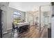 Bright dining area with large windows, modern gray flooring, and an open view to the foyer and living spaces at 18251 East Rd, Hudson, FL 34667