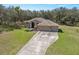 Home with a well-manicured lawn and a circular driveway at 18251 East Rd, Hudson, FL 34667