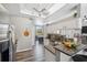 View of kitchen with granite counters, stainless refrigerator, and connecting breakfast nook at 18251 East Rd, Hudson, FL 34667