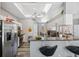 Modern kitchen with stainless steel appliances, a breakfast bar, and an open view to the dining area at 18251 East Rd, Hudson, FL 34667