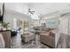 Spacious living area with modern gray flooring, an open layout, and access to a screened-in pool area at 18251 East Rd, Hudson, FL 34667