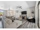 Inviting living room featuring modern gray flooring, a comfortable sectional sofa, and an open layout design at 18251 East Rd, Hudson, FL 34667