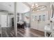 Inviting living area with wood floors, large front door, chandelier, and bright windows at 18251 East Rd, Hudson, FL 34667