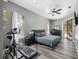 Main bedroom with wood-look floors, ceiling fan, access to screened porch, and walk-in closet at 18251 East Rd, Hudson, FL 34667