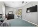 Spacious main bedroom features sliding glass doors to the pool area and neutral paint at 18251 East Rd, Hudson, FL 34667