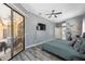 Spacious main bedroom features sliding glass doors to the lanai, wood-look floors, and neutral paint at 18251 East Rd, Hudson, FL 34667