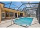 Relax in the enclosed pool area with screened enclosure, providing a private oasis for swimming at 18251 East Rd, Hudson, FL 34667