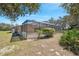 A screened-in patio with an adjacent lawn area provides ample outdoor space at 18251 East Rd, Hudson, FL 34667