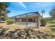 The screened-in patio offers a great outdoor living space with privacy and shade at 18251 East Rd, Hudson, FL 34667