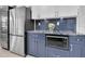 Close-up of a kitchen area with stainless steel appliances, custom cabinetry and tiled backsplash at 19123 Cherry Rose Cir, Lutz, FL 33558