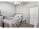 Cozy bedroom with gray walls, ceiling fan, carpet floors, and a bed with storage drawers at 215 Arbor Woods Cir, Oldsmar, FL 34677