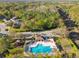 Aerial view of a community pool and playground with mature landscaping and trees at 215 Arbor Woods Cir, Oldsmar, FL 34677