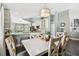 Bright dining area adjacent to a modern kitchen, featuring a large dining table and stylish decor at 215 Arbor Woods Cir, Oldsmar, FL 34677