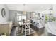 Open-concept dining room and kitchen area with modern light fixture and breakfast bar at 215 Arbor Woods Cir, Oldsmar, FL 34677