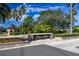 Stone entrance to the Bay Arbor community with mature trees and landscaping in the background at 215 Arbor Woods Cir, Oldsmar, FL 34677