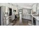 Open kitchen with stainless steel appliances, a kitchen island, and bright lighting at 215 Arbor Woods Cir, Oldsmar, FL 34677