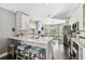 Modern kitchen with marble countertops, stainless steel appliances, and a cozy breakfast nook at 215 Arbor Woods Cir, Oldsmar, FL 34677