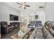 Spacious living room featuring a ceiling fan, hardwood floors, and comfortable furniture at 215 Arbor Woods Cir, Oldsmar, FL 34677