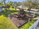 Community playground featuring slides, climbing structures and picnic tables in a park like setting at 215 Arbor Woods Cir, Oldsmar, FL 34677