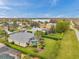 An aerial view of a single-Gathering home with a screened-in pool, surrounded by lush landscaping in a serene community at 2336 Edelweiss Loop, Trinity, FL 34655