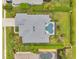 Top-down aerial view showcasing the backyard oasis with pool, landscaping, and outdoor living space of single-Gathering home at 2336 Edelweiss Loop, Trinity, FL 34655